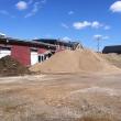 Piles of mulch, sand and rough fill on Sunday obscured the city-owned building most recently home to the Belfast Maskers. The property is being used as a staging area for materials for the Belfast Harbor Walk project, which broke ground last week. (Photo by Ethan Andrews)