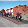 Harbor Walk grand opening attendants pass in front of one of several commercial properties that account for an inland detour on the mostly-waterfront path. (Photo by Ethan Andrews) 