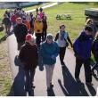 The group marches north through Heritage Park on the way to the trail’s end at the Armistice footbridge. (Photo by Ethan Andrews)