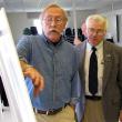 Stephen Miller, executive director of the Islesboro Islands Land Trust, left, gestures to a map of upper Penobscot Bay as Rep. Mick Devin looks on. (Photo by Tom Groening)