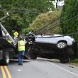 A car is loaded onto a wrecker after toppling a utility pole on Washington Street. (Photo by Sarah Thompson)