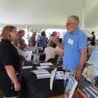 Author Philip C. Baker chats with a festivalgoer at Maine Author's Publishing's Book Festival. Photo courtesy Maine Author's Publishing