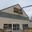 Last touches on the sign for the new Edwards Brothers Supermarket in Searsport. Photo by Kay Stephens