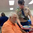 At the Veteran's Appreciation Beef Stew Dinner put on by the Warren Historical Society, veteran Danny Swindler is served lunch by his grandson Star Scout Logan Bailey, who is a member of Troop 254 Warren. (Photo courtesy Chuck Mahaleris)