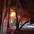 Well after big flames were suppressed, sparks found oxygenation from a new hole in the roof. (Photo by Sarah Thompson)