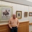Artist Peter Giustra stands with some of his works, now on display at MaineHealth Pen Bay Hospital. (Photo courtesy MaineHealth)