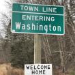 DOT Washington Sign Town Line Sign with Welcome Home sign posted under it