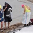 Snow Moon Selkies’ 9 a.m. dip at Naskeag Point in Brooklin was the height of Sunday’s storm. Sarah Havener on the left by Monday had raised $1,600 for Finding Our Voices. (Photo by Michael Percy)