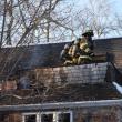 Camden firefighters cut and saturate around a chimney pipe at 201 Chestnut Street, in Camden, Feb. 11, 2025. (Photo by Sarah Thompson)