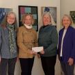 Gallery owners present a check to New Hope Midcoast. L-R: Leslie Moore; Rebekah Parades, Executive Director of New Hope Midcoast; Debbie Mitchell, and Betty Schopmeyer. (Photo courtesy Local Color Gallery)