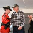 Legendary Maine Game Warden Dennis McIntosh (center) is congratulated by Lt. Aaron Cross and his wife, Carmen.