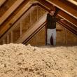 a man standing in an attic. 