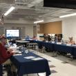 a group of adults at a conference table