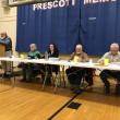 three men and two women sit at a table officiating a meeting
