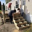 Student volunteers install a ramp, enabling an elderly homeowner to age in place. (Photo courtesy Midcoast Habitat for Humanity)