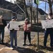 A group of protestors hold signs supporting local libraries