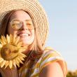 girl holding sunflower in sunlight