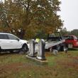 damaged car being pulled onto flatbed truck