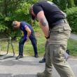 Applying tourniquets to one's own limbs. The TECC Class at the end of the weekend. (Photo courtesy Connor Howland/Camden Fire Dept.)