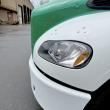 front of the bus shown only, a focus of on the headlights.