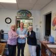 Diane Zollo and Faith Vautour, from Goose River Golf Club's Ladies League, present AIO food pantry CEO Alan Kearl with $1200.