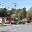 Fire trucks wait to be released from a shed fire