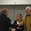 Eric Quatrano shakes hands with Select Board member Peter Lammert as Chris Rector and Kimberly Matthews look on. (Photo by Sarah Thompson)
