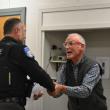 Patrol Officer Chris Hansen shakes hands with Select Board Chair Chris Rector. (Photo by Sarah Thompson)