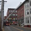 Ladder truck raised into position to reach the roof of a building