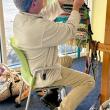 Visitor adding to a community tapestry on an Earth Loom. (Photo courtesy Rockport Public Library)