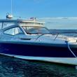 A well-equipped Nimbus W9 buttoned up against the Maine weather with full side curtains and an electrically powered sunroof. The mooring bridle takes advantage of both cleats on the bow. The electric anchor windlass can be operated with a remote control from anywhere on the boat; the remote also can run the bow thruster. The touches of orange are wind vanes on accessory whirligigs meant to deter gulls and cormorants. 