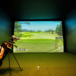 Learn to Play Golf Indoor virtual golf screen with a bag of golf clubs