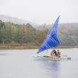 The catamaran, The Snail, sets sail with its test sail, a tarp. (Photo courtesy David Garrison)