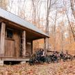 Four people ride adaptive mountain bikes toward a structure