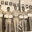 Group photo of five soldiers and their certificates