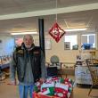 Robert "Biker Bob" Sheehan standing before The Devils Pride Motorcycle Club's donation of Christmas stockings to the Coastal Recovery Community Center located in Rockland. Photo courtesy Bob Sheehan