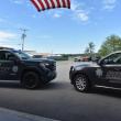 KCSO truck and SUV under American flag
