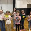 Six students show off their raffle wins