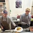 Ryan Tinker and Crispin Goodnow, in the Camden Hills Regional High School kitchen Jan. 28, serving up Graffam Seafood's Maine Coiast Founder Fishcake with a topping of Wakame Slaw. (Photo by Lynda Clancy)