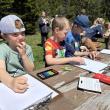 children work with crayons at a picnic table