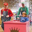 Adults in Nintendo costumes, girl in pink cart