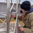 Female looks at section of weather tower