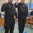 two officers raise their right hands