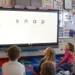 kids looking at a screen that displays the word 'snap'