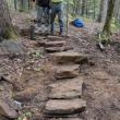 Two men stand at top of rock steps