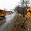 school bus driving down a street.