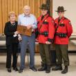 Four adults pose with award plaque