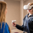 College student tests virtual reality head set