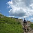 hiker climbing toward peak