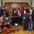 band members pose with instruments on small stage